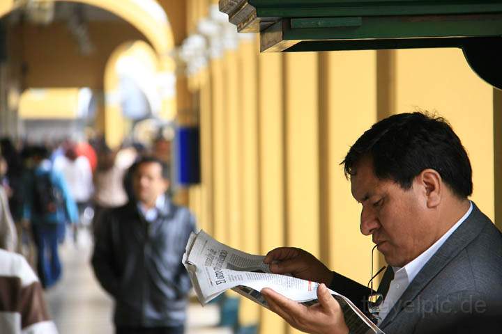 sa_pe_lima_004.jpg - Ein Geschftsmann liest Zeitung whrend er die Schuhe geputzt bekommt